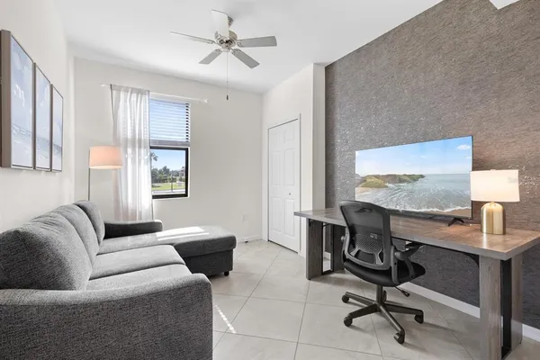 a view of a livingroom with workspace and a couch