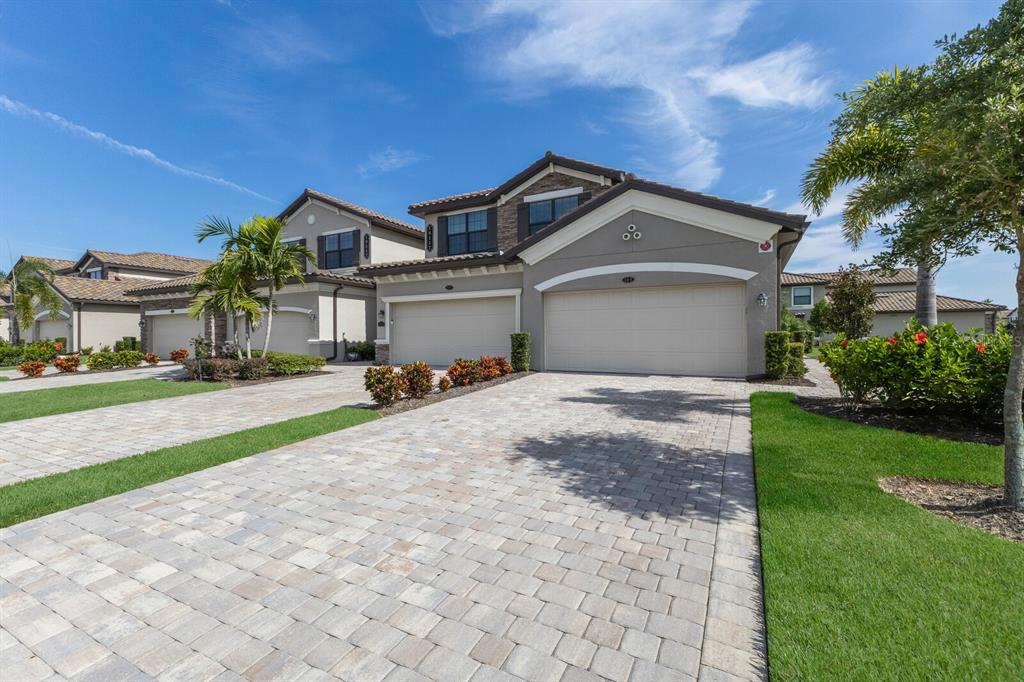 18117 Gawthrop Drive, Unit 104 Bradenton, FL 34211 - Photo 3 of 54 a front view of a house with a yard and garage