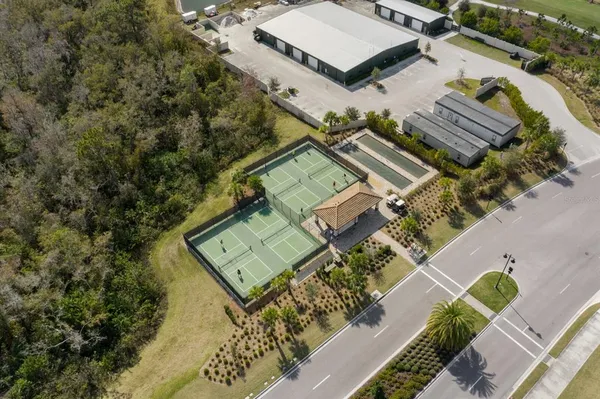 an aerial view of a house with a garden and lake view