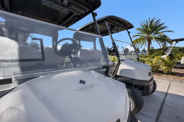 a front view of a house with a garden and lake view