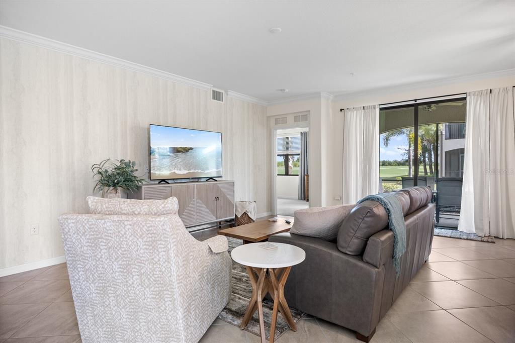 18117 Gawthrop Drive, Unit 104 Bradenton, FL 34211 - Photo 7 of 54 a living room with furniture and a large window