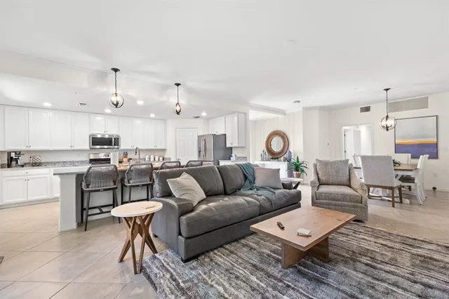 a living room with furniture and view of kitchen