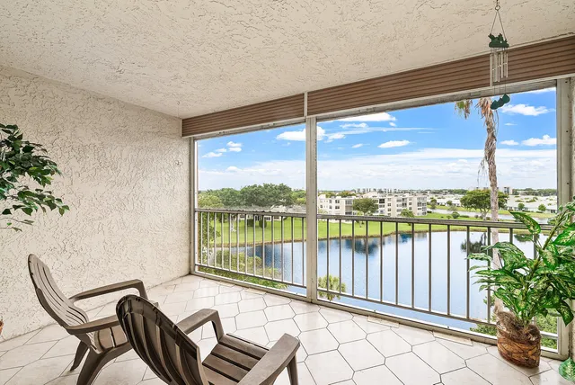 a view of a balcony with lake view and a potted plant