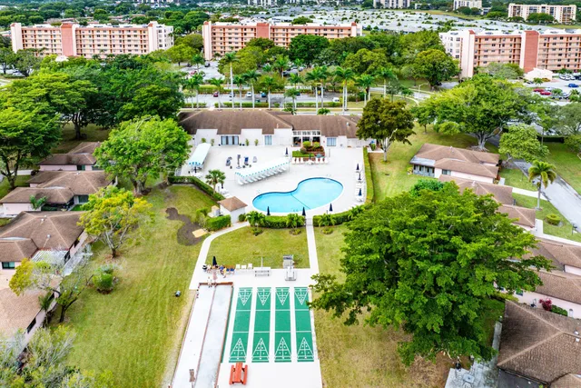 an aerial view of a house with outdoor space and swimming pool