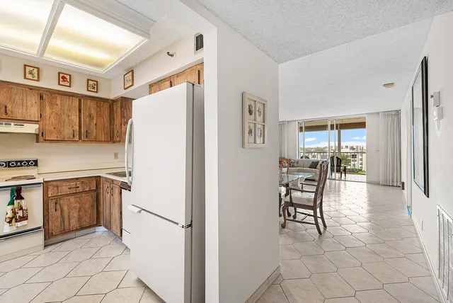 a kitchen with stainless steel appliances a refrigerator and a stove top oven
