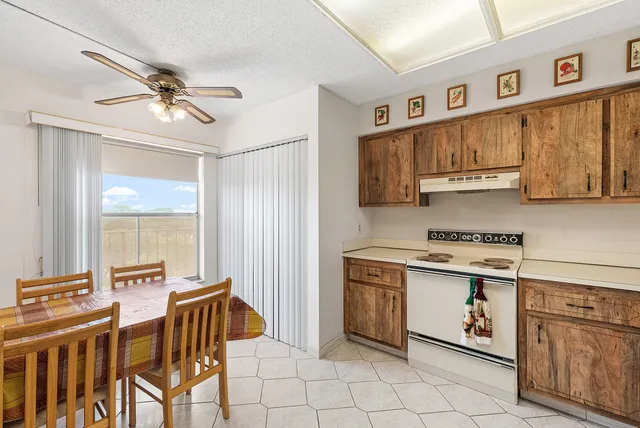 a kitchen with appliances cabinets and furniture