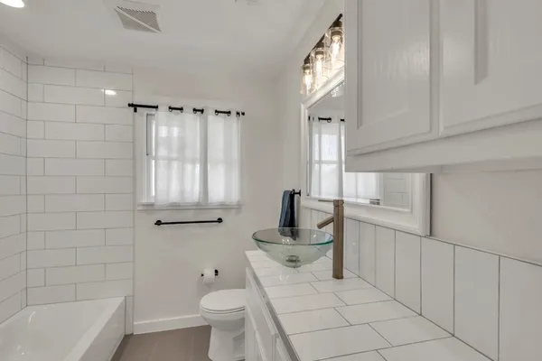 a kitchen with granite countertop a sink a counter top space stainless steel appliances and cabinets