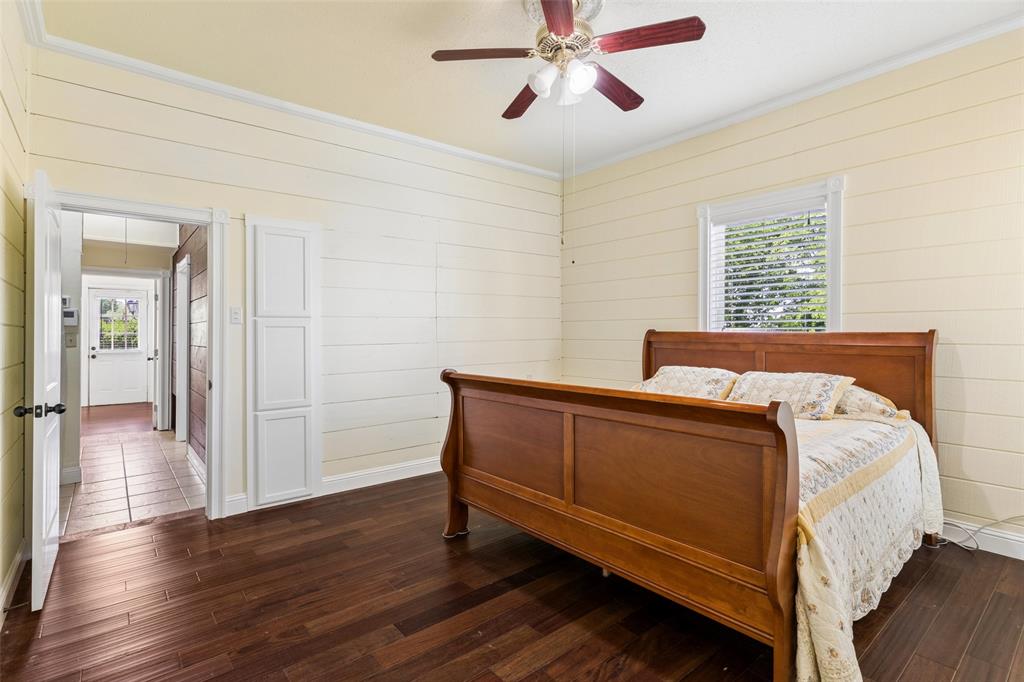 5824 Boone Street Sachse, TX 75048 - Photo 22 of 40 a bedroom with a bed and wooden floor