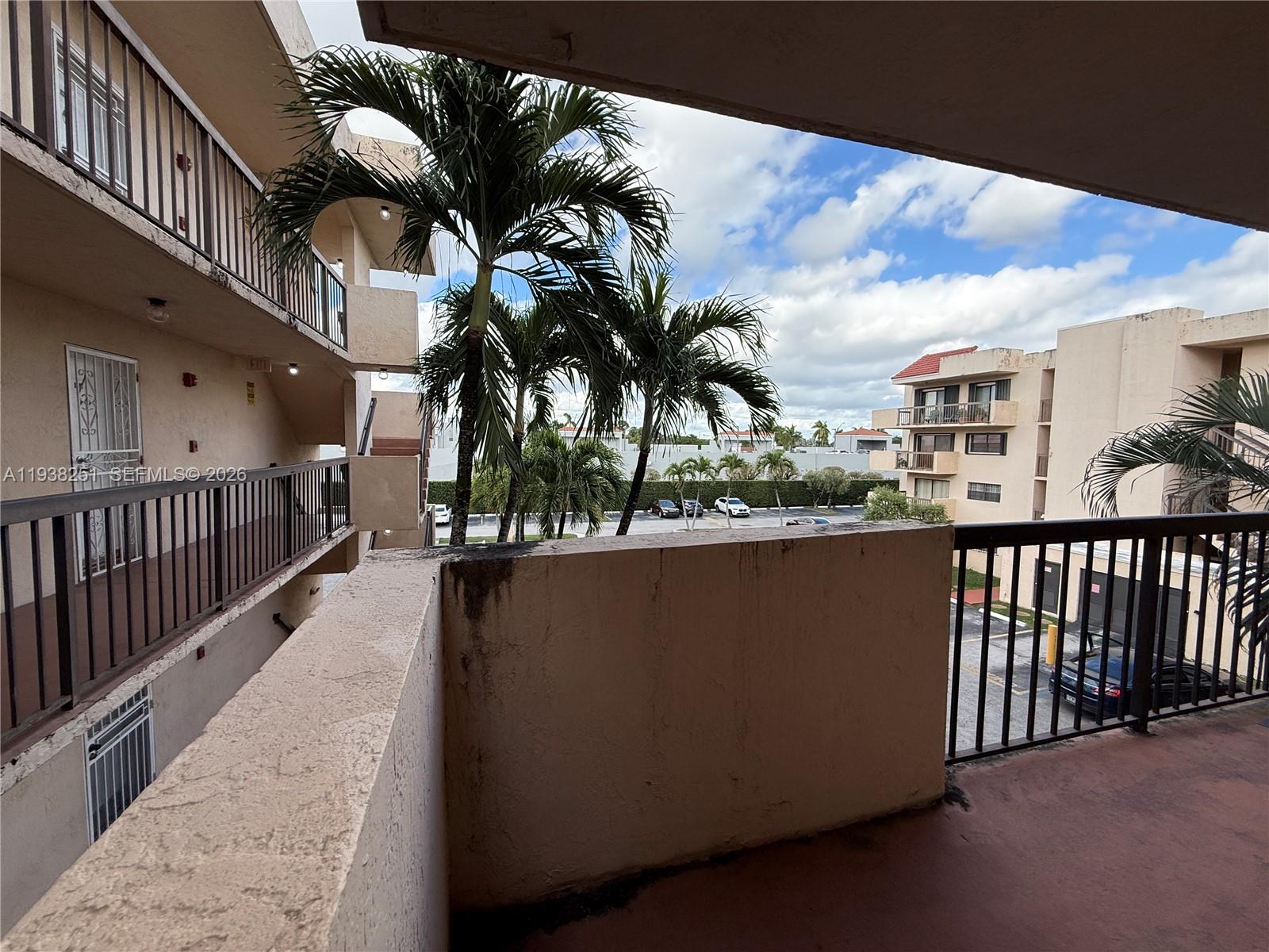 995 Southwest 84th Avenue, Unit 304 Miami, FL 33144 - Photo 12 of 15 a view of balcony with furniture