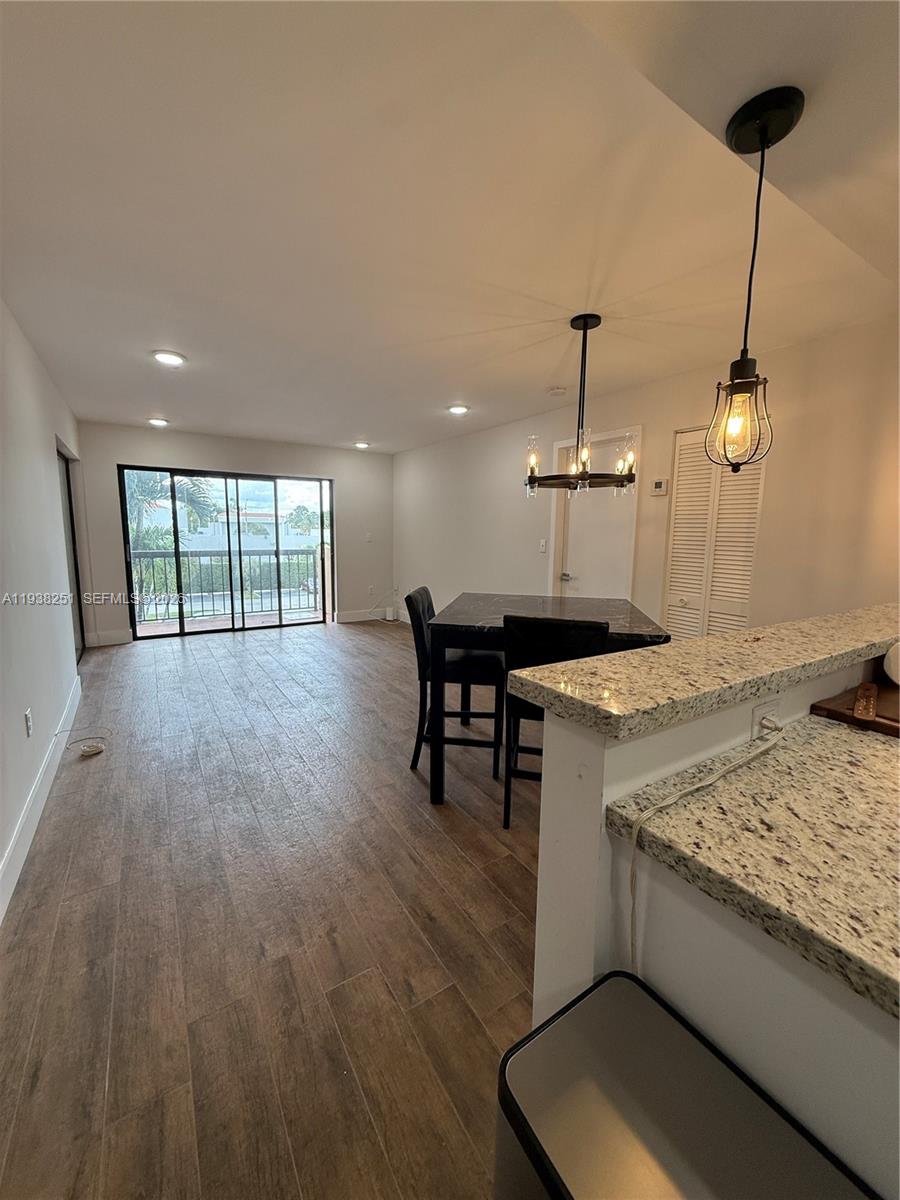 995 Southwest 84th Avenue, Unit 304 Miami, FL 33144 - Photo 2 of 15 a view of a kitchen with a sink and wooden floor