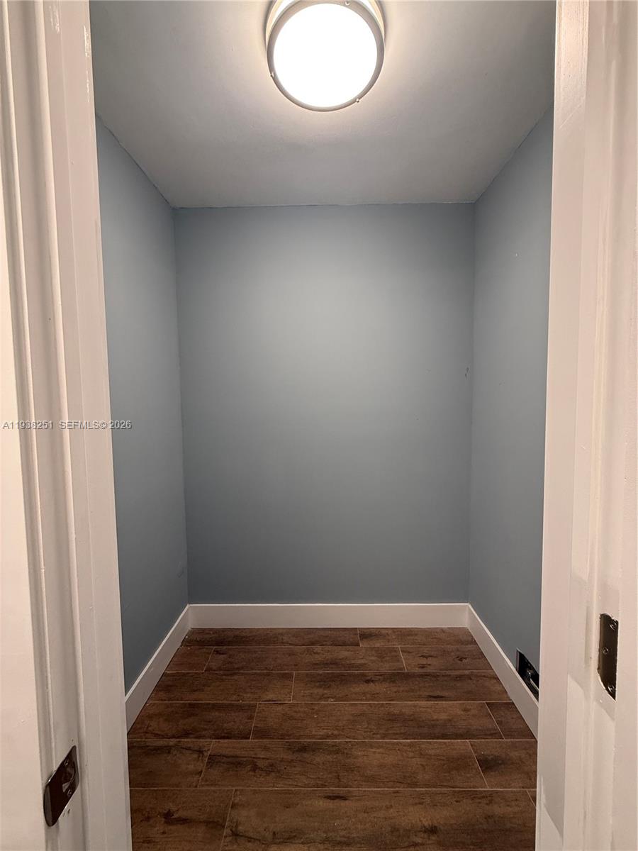 995 Southwest 84th Avenue, Unit 304 Miami, FL 33144 - Photo 7 of 15 a view of a small space with wooden floor and sink