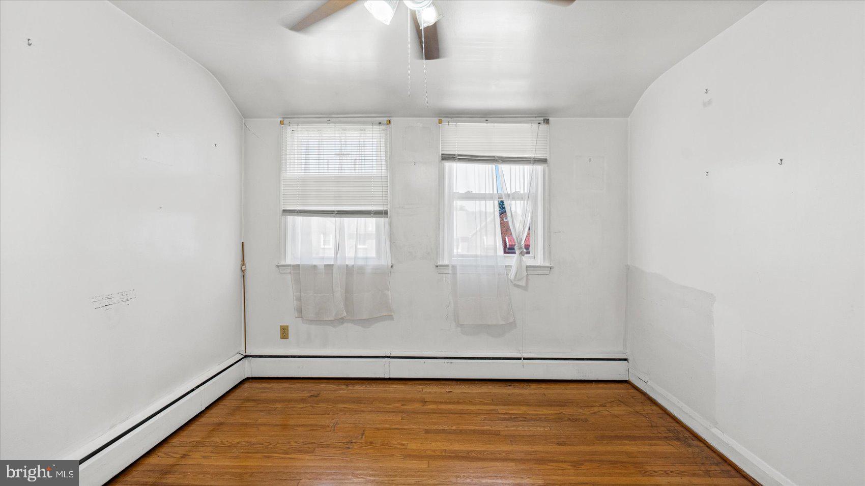 1805 Crestview Road Baltimore, MD 21239 - Photo 21 of 39 an empty room with wooden floor and windows