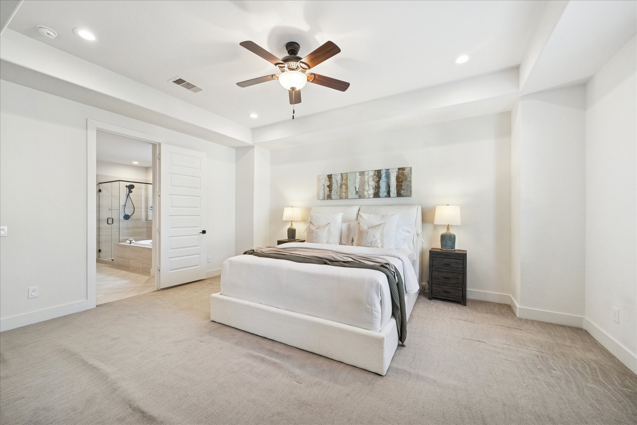1122 Thompson Street Houston, TX 77007 - Photo 17 of 25 a spacious bedroom with a bed and a ceiling fan