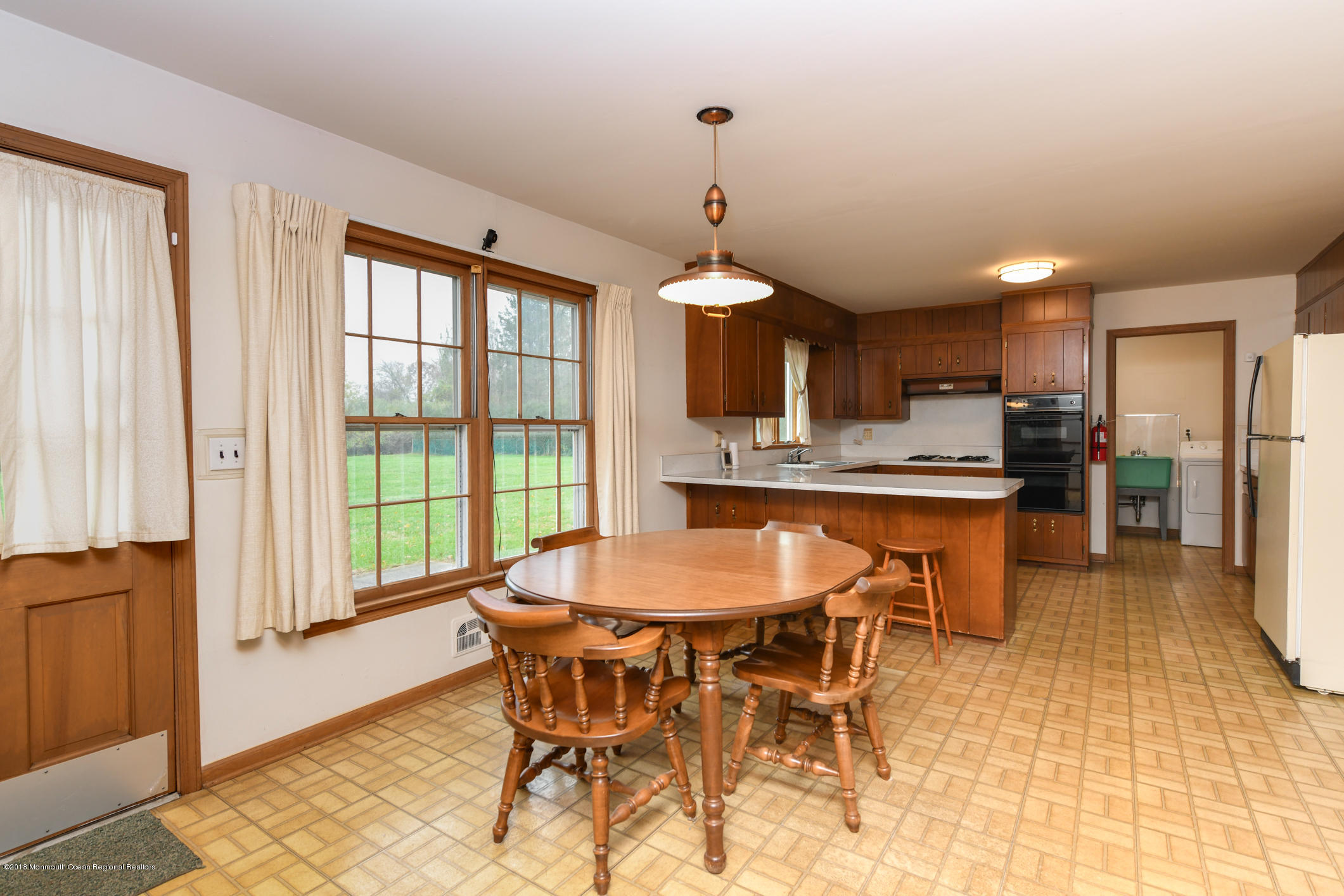 2 Green Hill Road Colts Neck, NJ 07722 - Photo 13 of 30 a dining room with stainless steel appliances kitchen island granite countertop a table chairs and a refrigerator