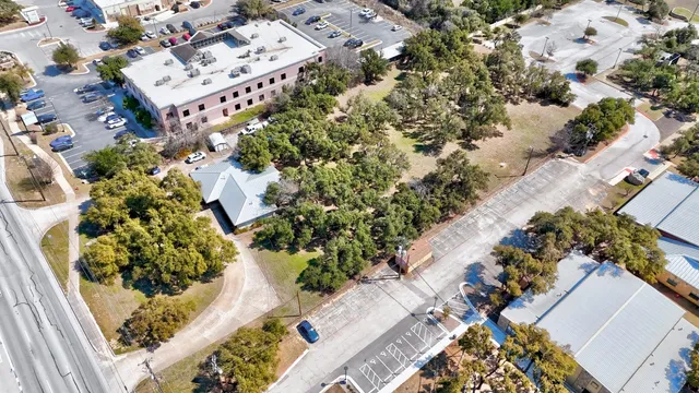 an aerial view of a house with a yard and flowers