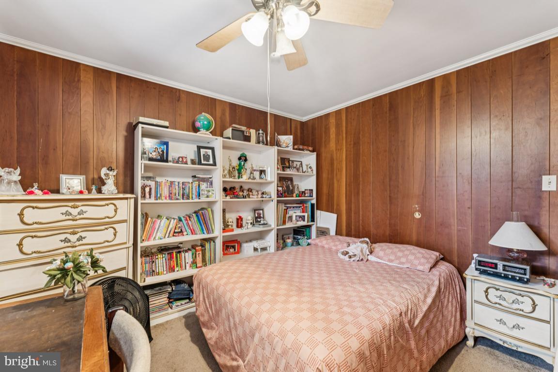 4910 Stan Haven Road Temple Hills, MD 20748 - Photo 12 of 25 a bed room with a bed and a book shelf