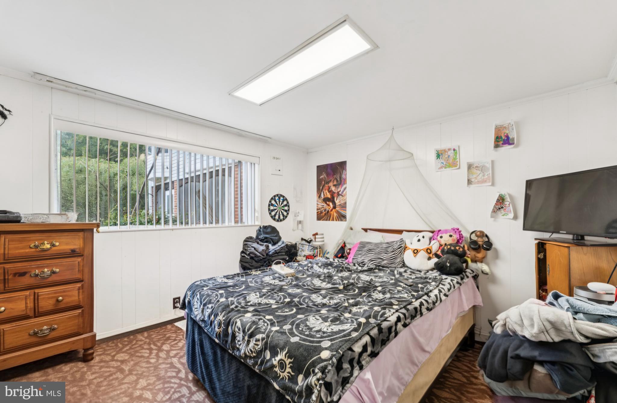 4910 Stan Haven Road Temple Hills, MD 20748 - Photo 18 of 25 a bed sitting in a bedroom next to a window with dresser