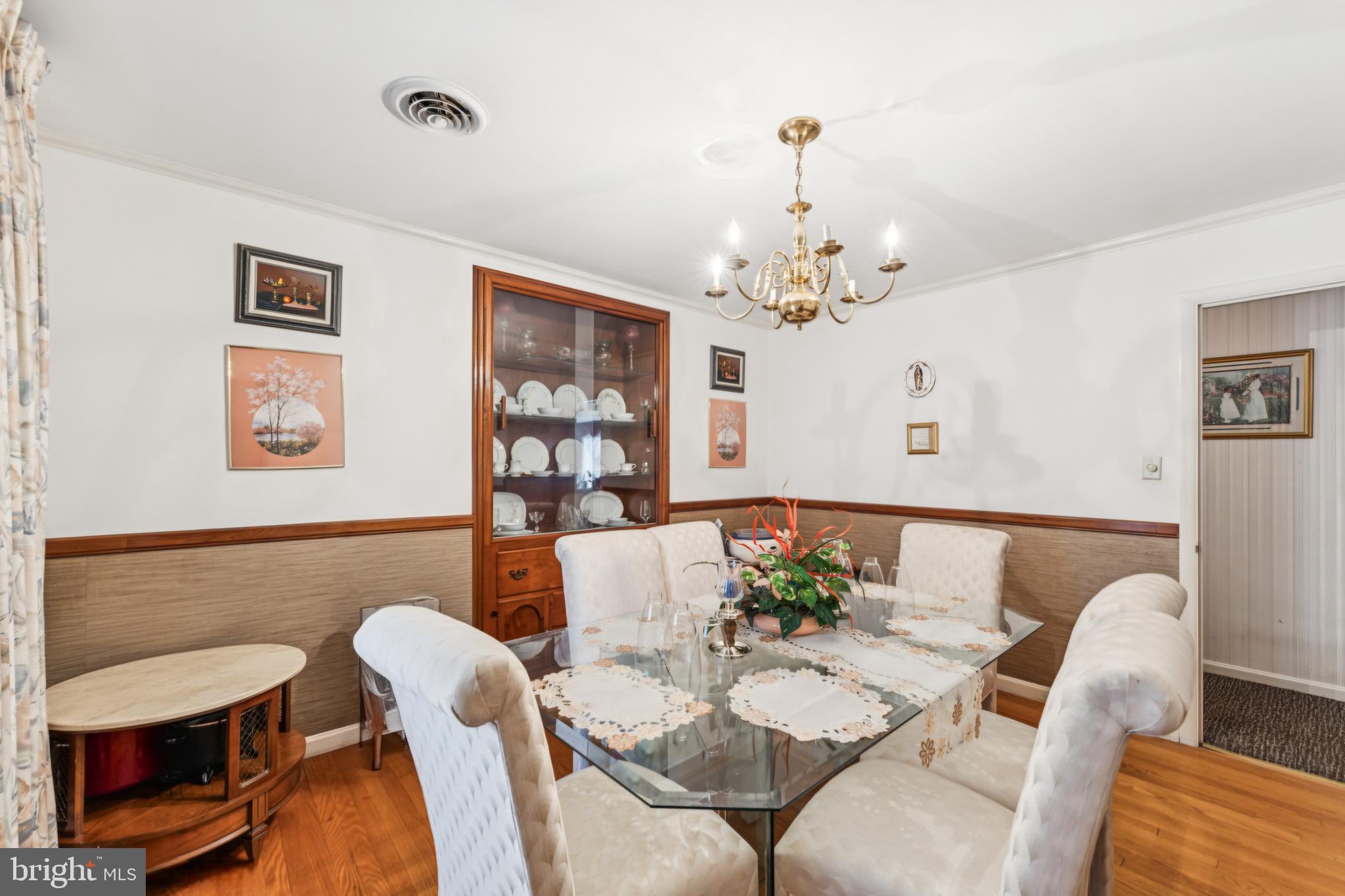 4910 Stan Haven Road Temple Hills, MD 20748 - Photo 8 of 25 a view of a dining room with furniture a chandelier and wooden floor