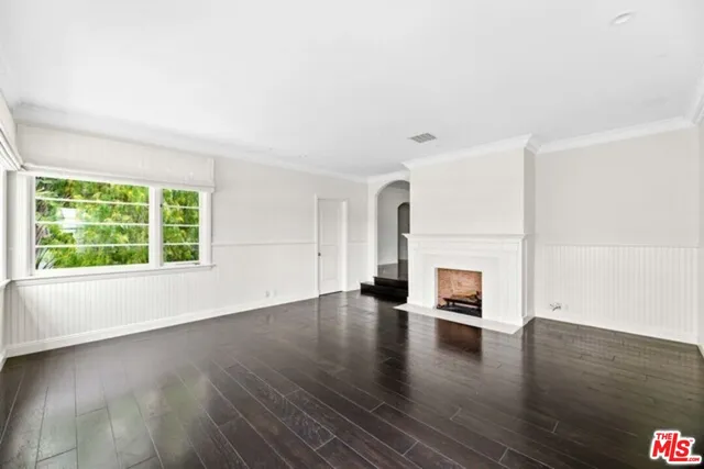 an empty room with wooden floor and a window