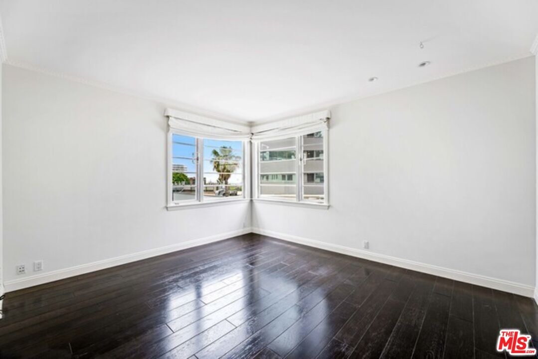 9233 1/2 Doheny Road West Hollywood, CA 90069 - Photo 12 of 17 a view of an empty room with wooden floor and a window