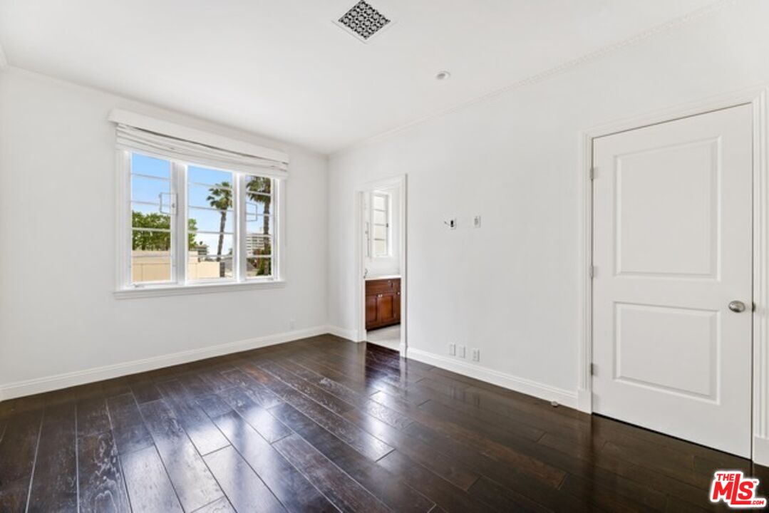 9233 1/2 Doheny Road West Hollywood, CA 90069 - Photo 14 of 17 a view of an empty room with wooden floor and a window