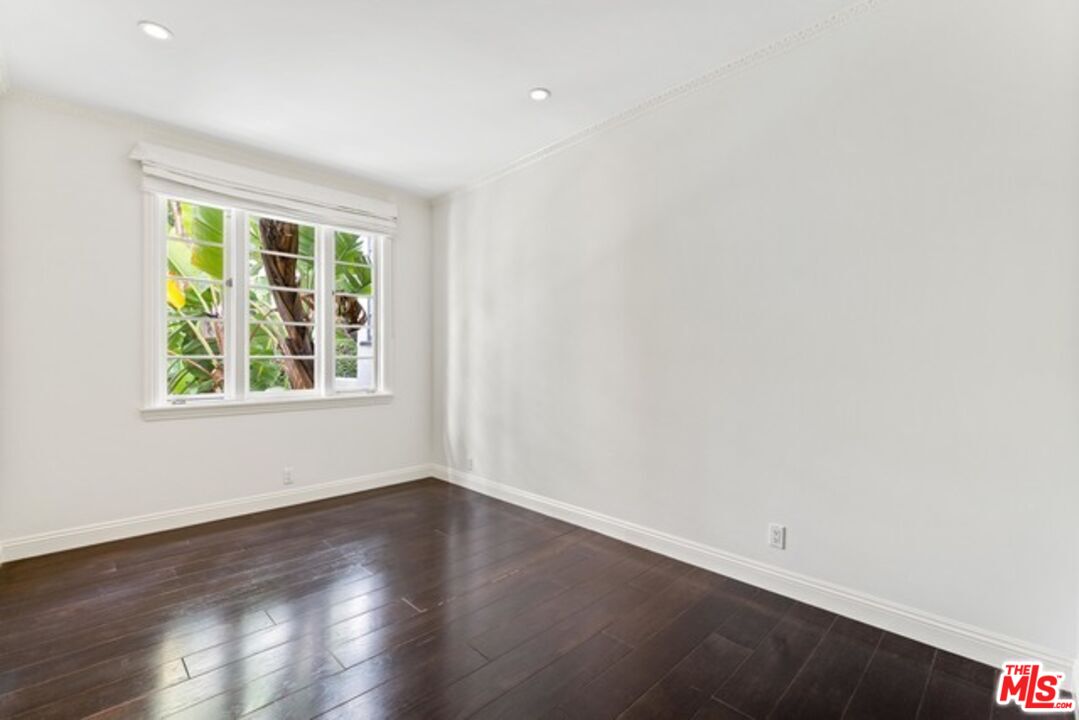 9233 1/2 Doheny Road West Hollywood, CA 90069 - Photo 15 of 17 wooden floor in an empty room with a window