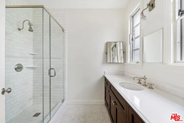 a bathroom with a granite countertop sink mirror and double