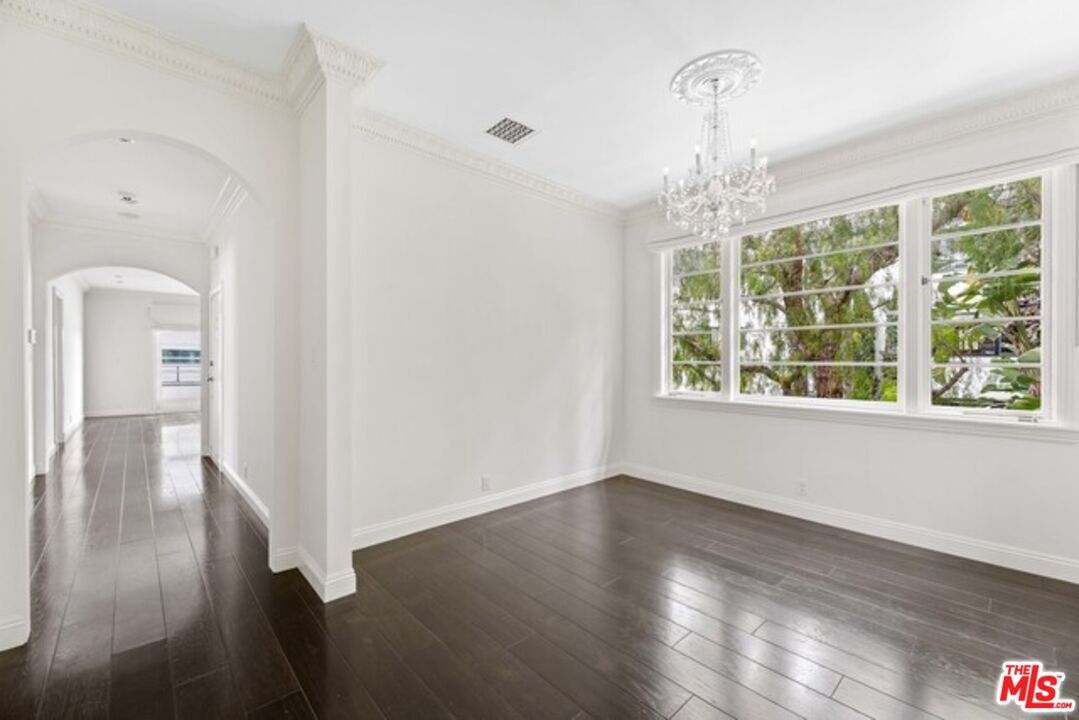 9233 1/2 Doheny Road West Hollywood, CA 90069 - Photo 7 of 17 wooden floor in an empty room with a window