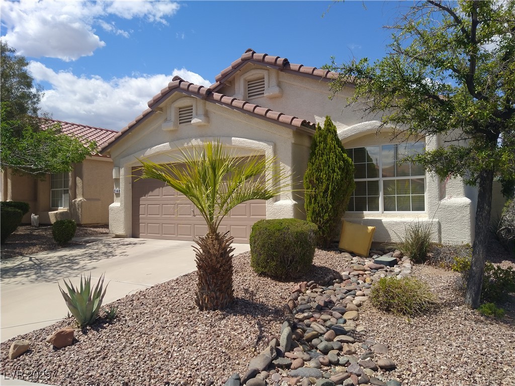 2148 Hidden Ranch Terrace Henderson, NV 89052 - Photo 1 of 31 Mediterranean / spanish-style home featuring an attached garage, stucco siding, driveway, and a tiled roof