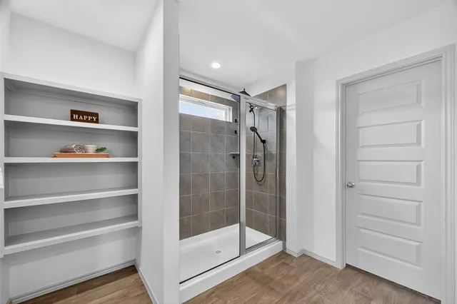 a bathroom with a shower and a window