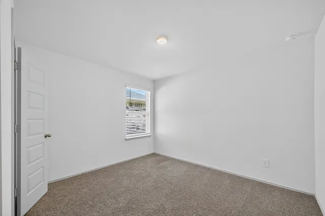 a view of an empty room and a window