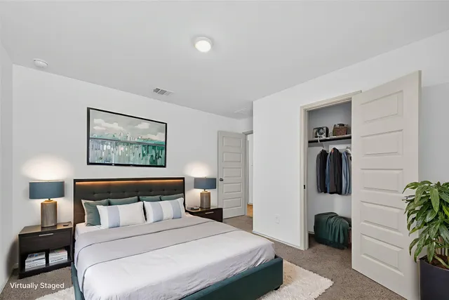 a bedroom with a bed and a painting on the wall