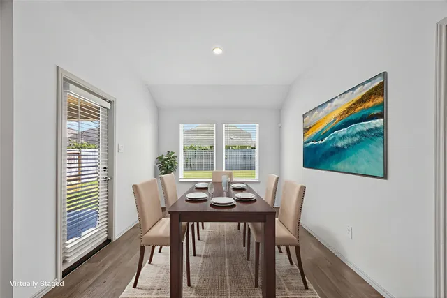 a view of a dining room with furniture and window