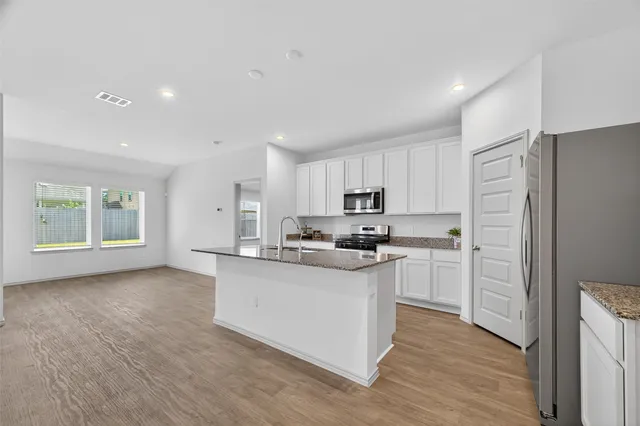 a kitchen with white cabinets and white appliances