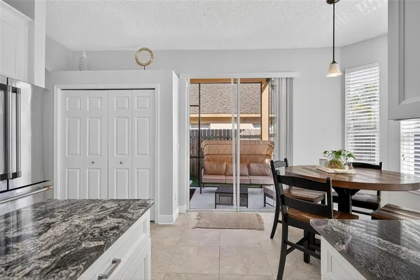a kitchen with stainless steel appliances granite countertop a sink a stove and a refrigerator