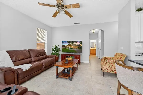a view of a hallway with wooden floor and a living room