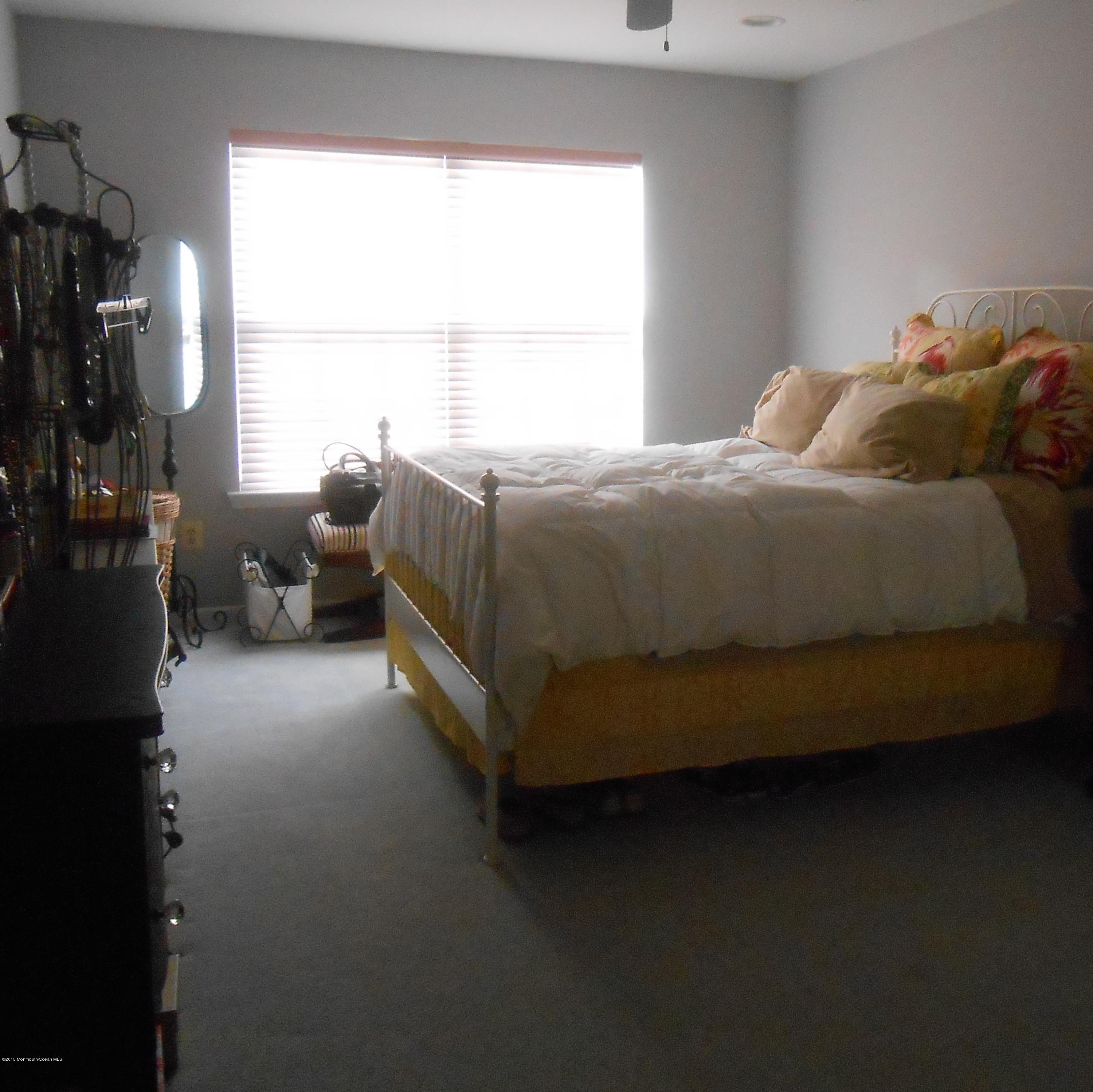 61 Racquet Road Wall, NJ 07719 - Photo 13 of 15 a bed sitting in a bedroom next to a window