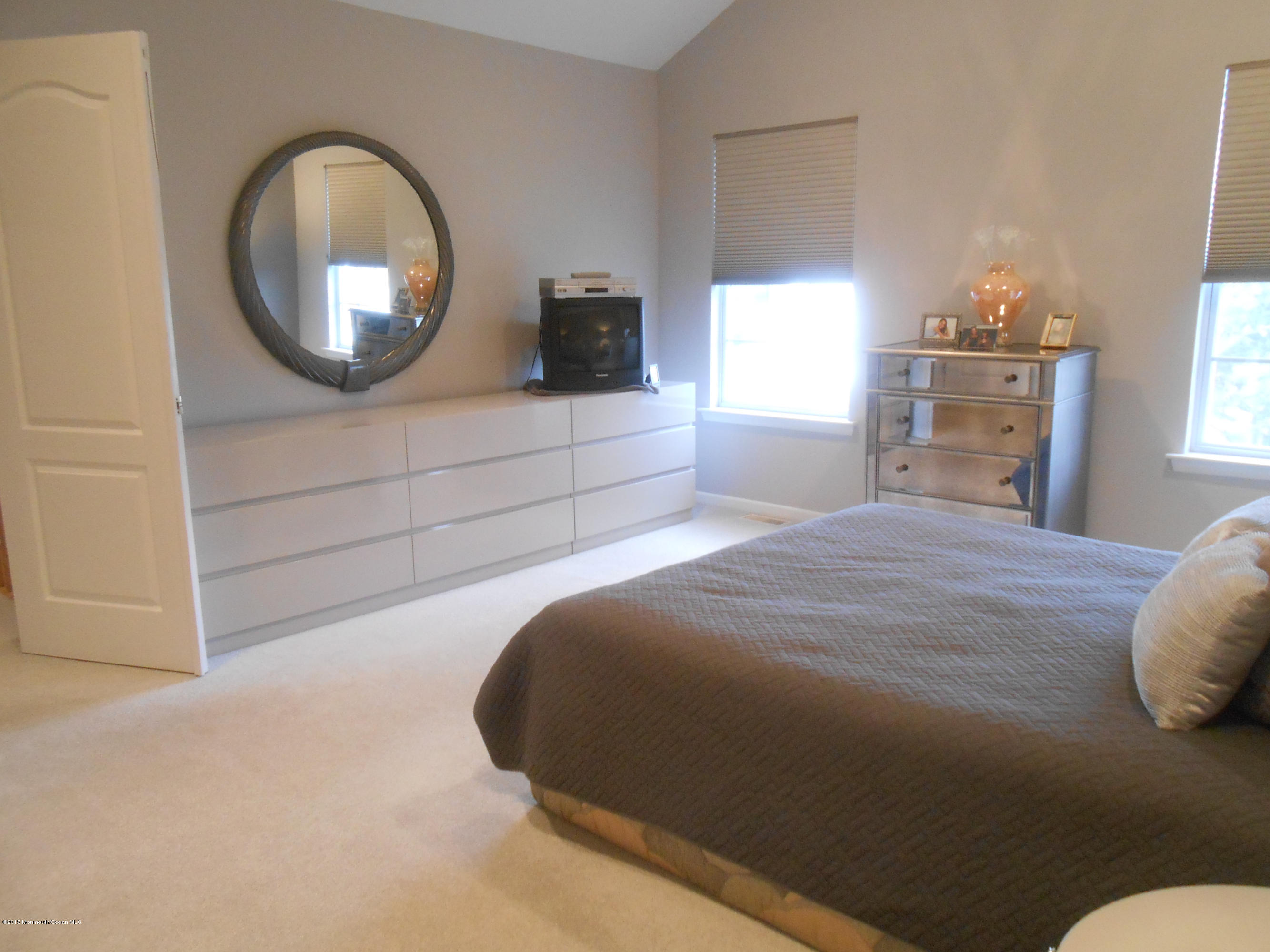 61 Racquet Road Wall, NJ 07719 - Photo 15 of 15 a bedroom with a bed and a mirror