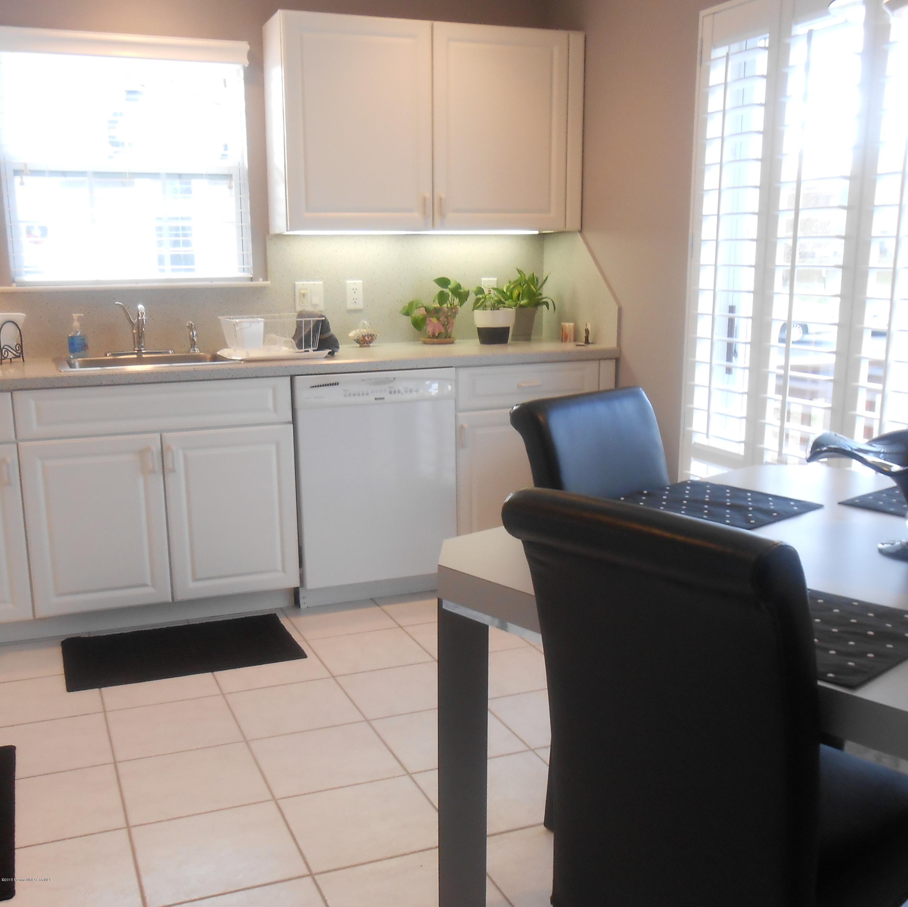 61 Racquet Road Wall, NJ 07719 - Photo 6 of 15 a kitchen with a sink a window and cabinets