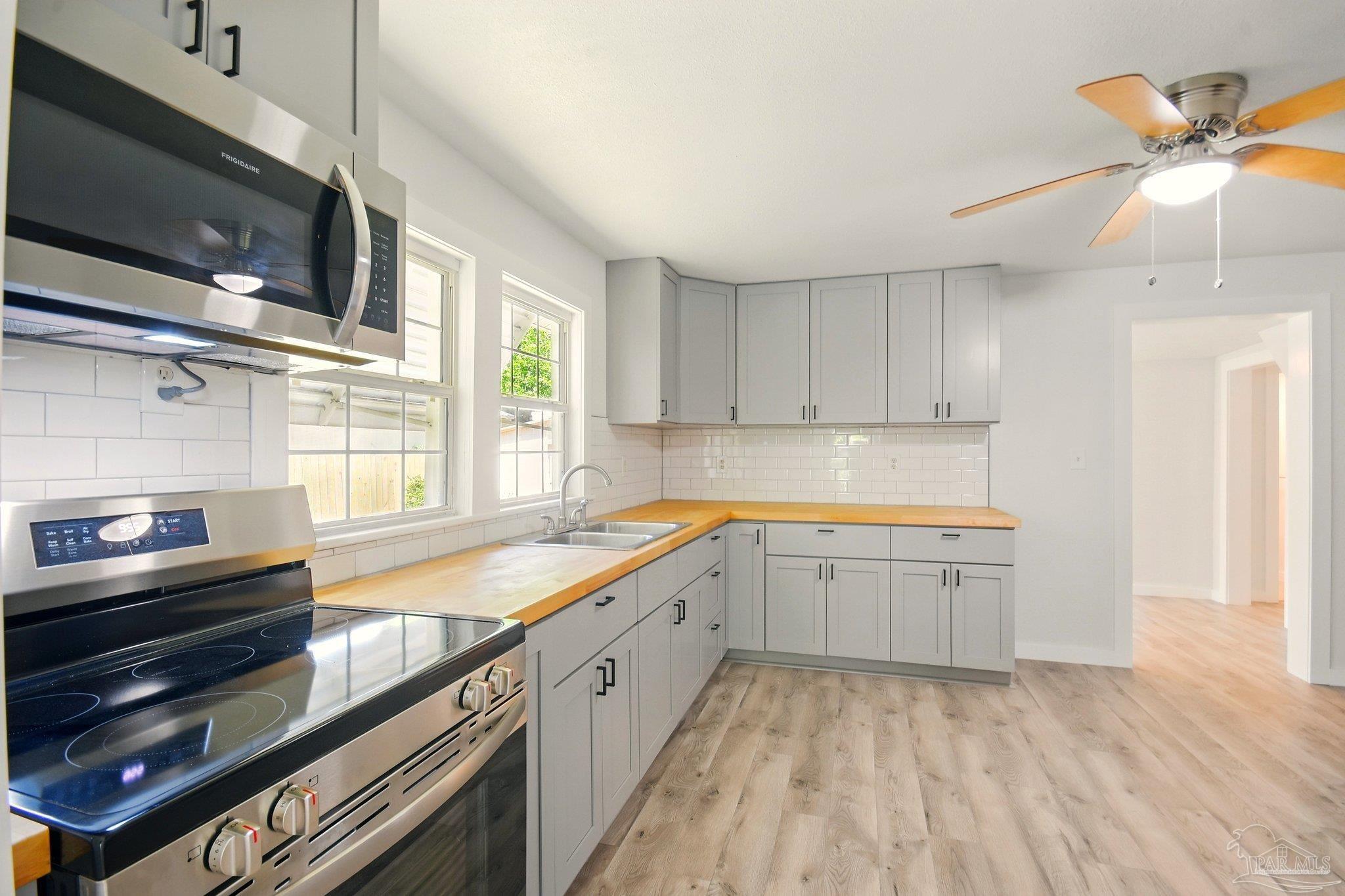 4329 Floridatown Road Pace, FL 32571 - Photo 13 of 32 a kitchen that has a sink and a stove