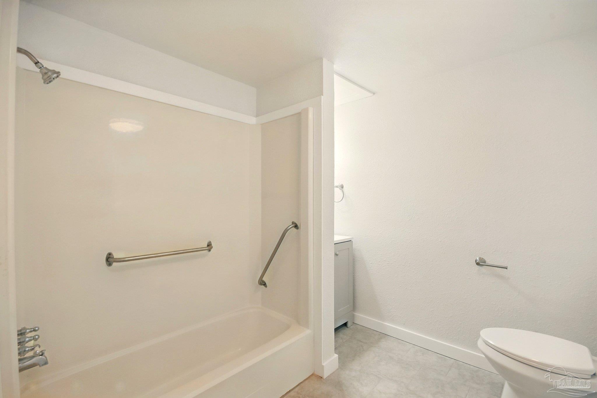 4329 Floridatown Road Pace, FL 32571 - Photo 17 of 32 a bathroom with a granite countertop bathtub and toilet