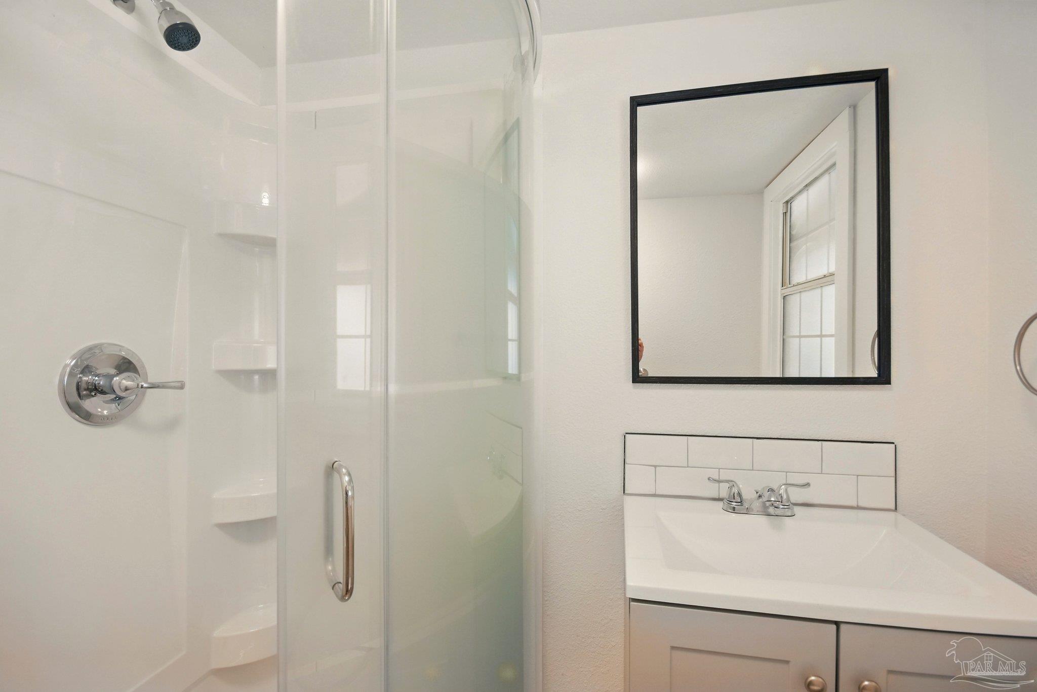4329 Floridatown Road Pace, FL 32571 - Photo 26 of 32 a bathroom with a sink vanity and mirror