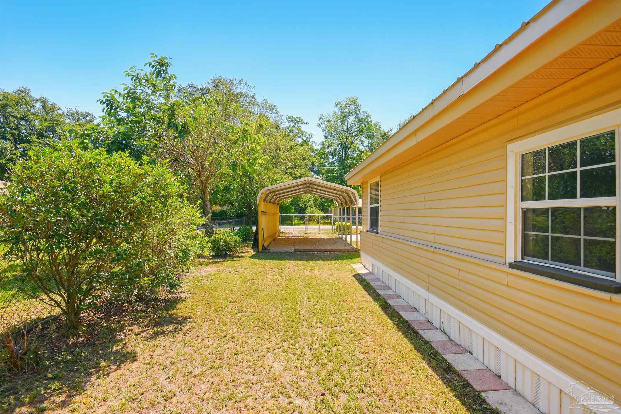 4329 Floridatown Road Pace, FL 32571 - Photo 32 of 32 a view of a house with a swimming pool