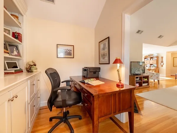 a view of a a dining room with furniture window and wooden floor