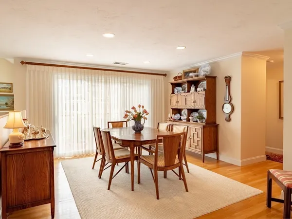 a dining room with a table chairs and a kitchen view