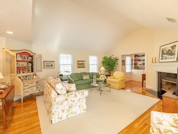 a living room with furniture mirror and a fireplace
