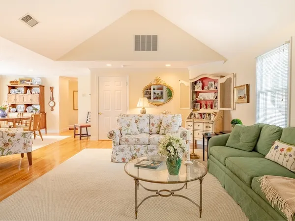 a living room with furniture and painting on the wall