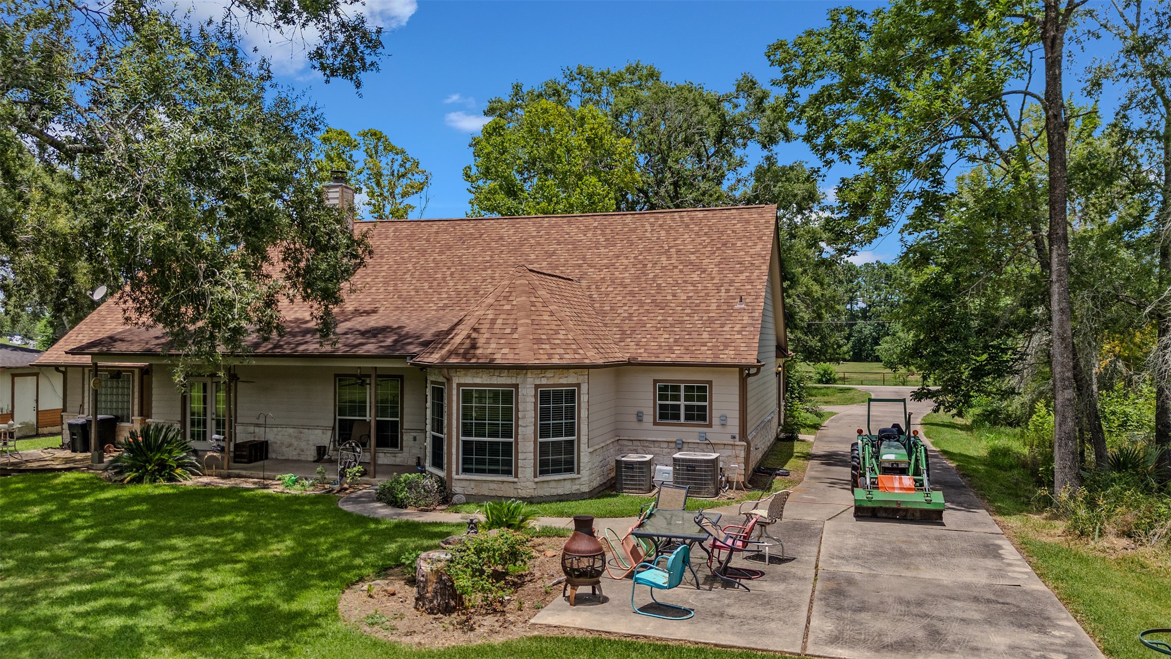 11692 Clark Lane Conroe, TX 77385 - Photo 22 of 35 The backyard of the home has an extended patio area and covered porch. Circle drive up front and plenty of parking here too!