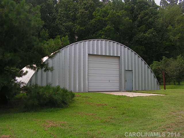 2022 Lawyers Road Indian Trail, NC 28079 - Photo 2 of 3 a view of backyard with potted plants and large tree