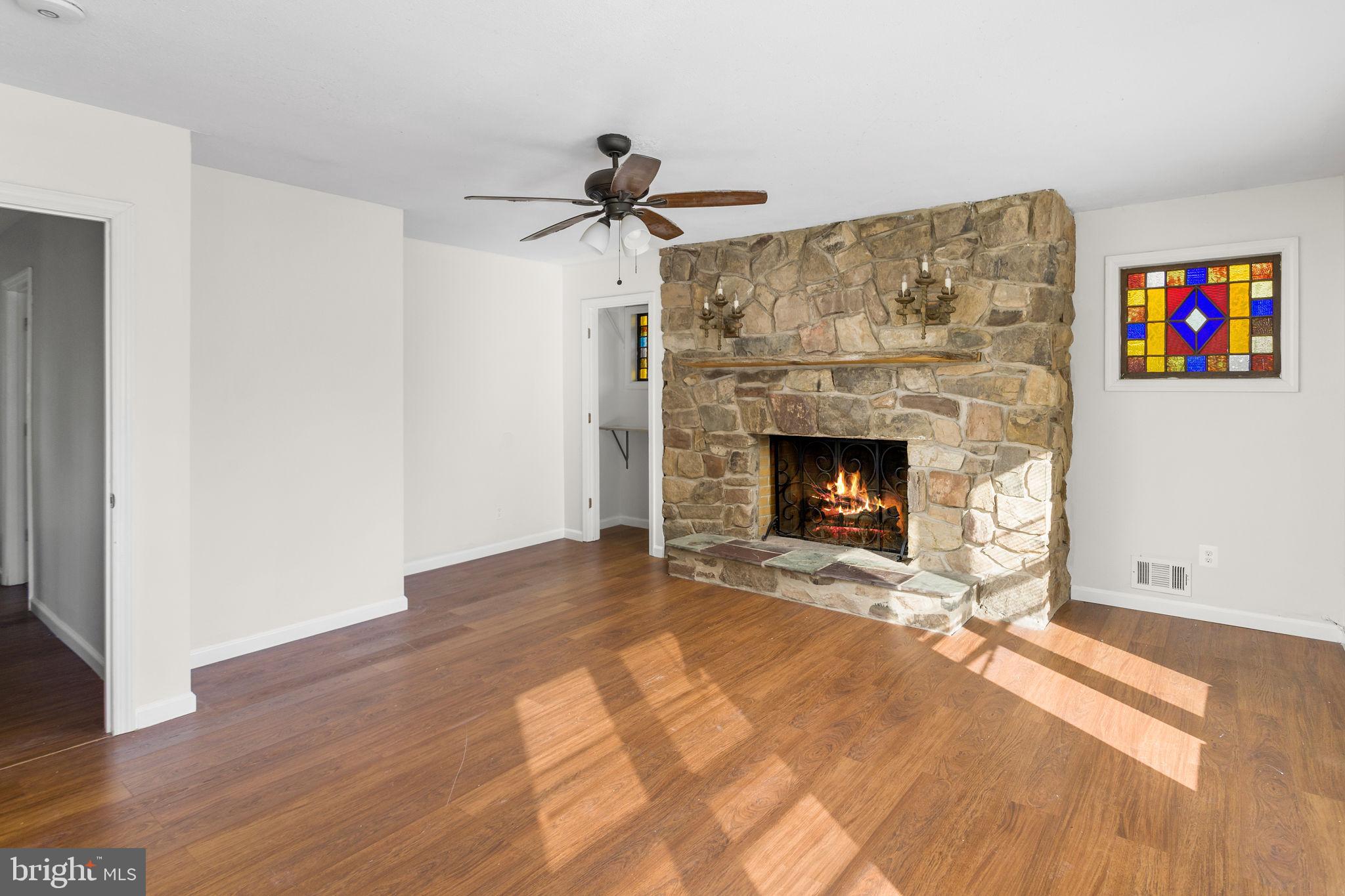 2264 Pennington Road Trenton, NJ 08638 - Photo 14 of 24 a living room with wooden floor and a fireplace